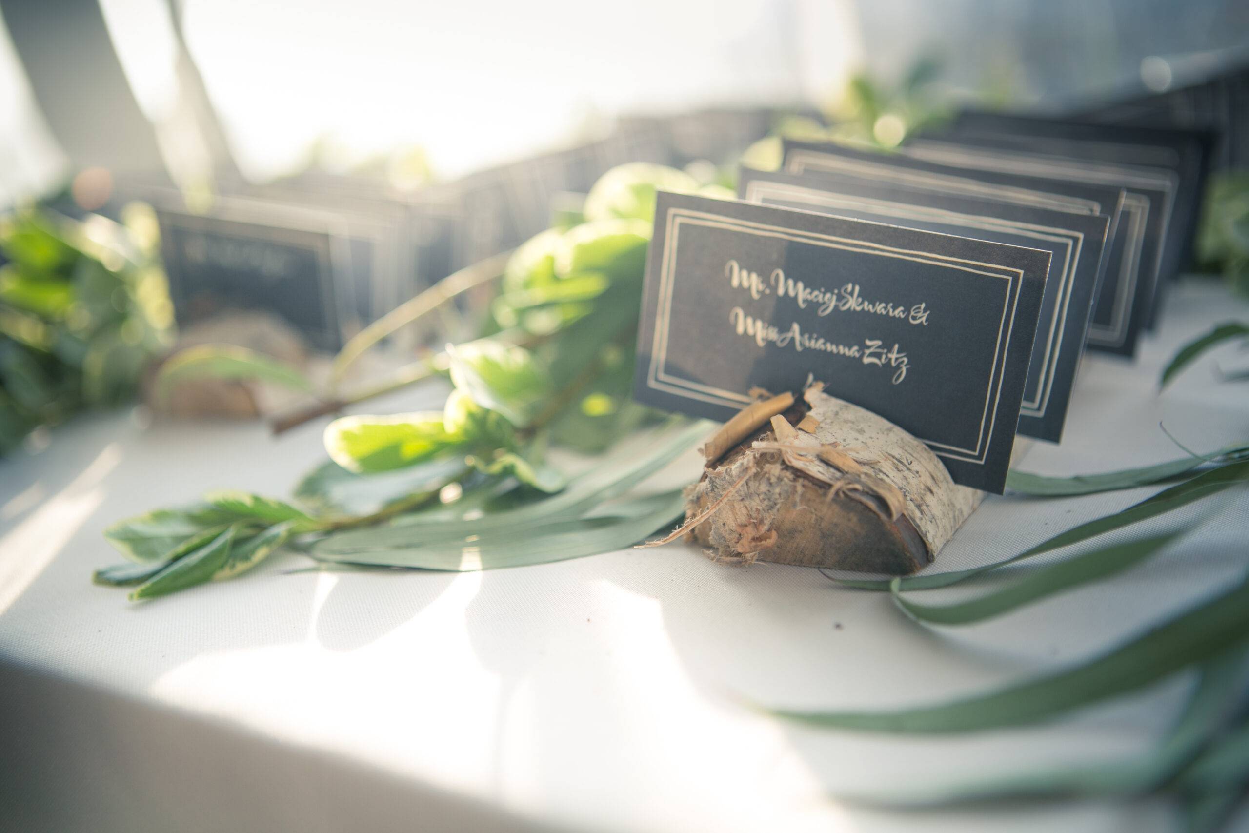 Pine tree placecard holders with black cards listing guest names