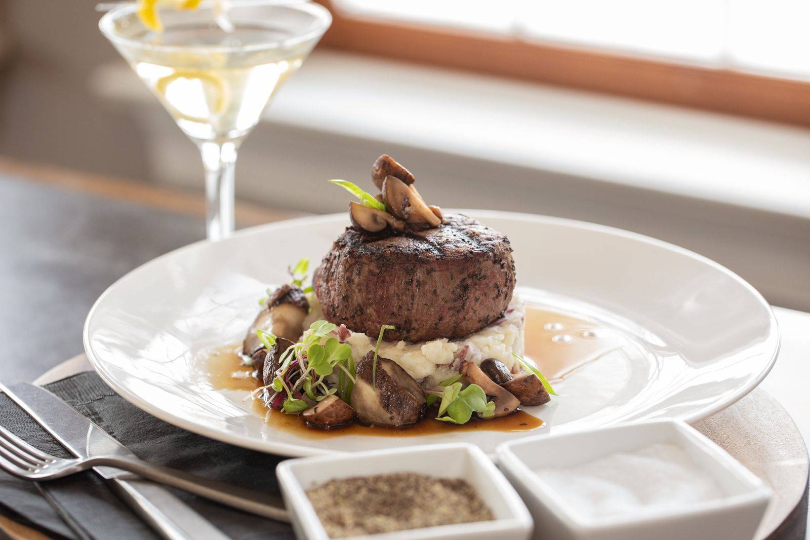 Plate of Filet Mignon over a bed of mashed potatoes and a mushroom reduction