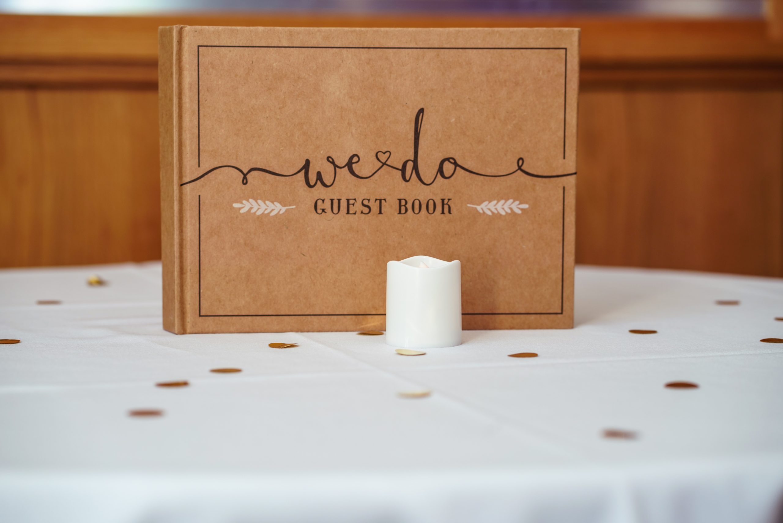 Brown wedding guest book on table